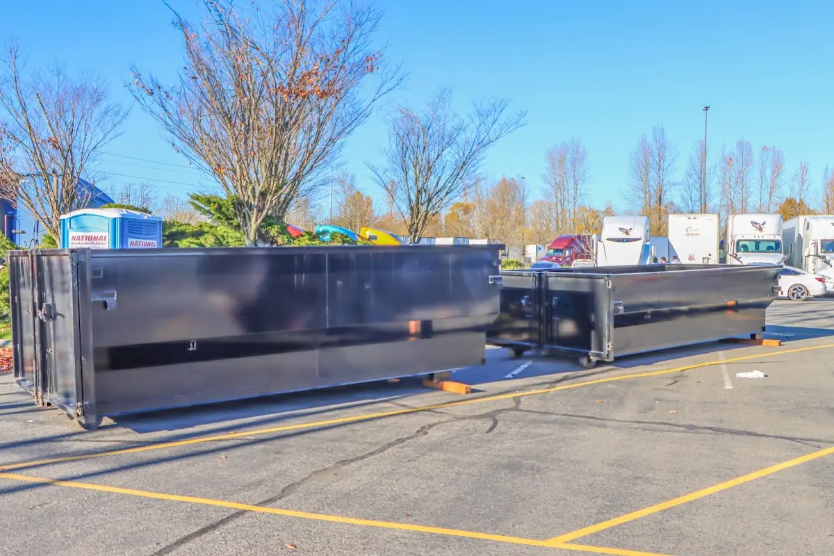 Professional dumpster rental service with roll-off container on residential driveway in Silver Spring